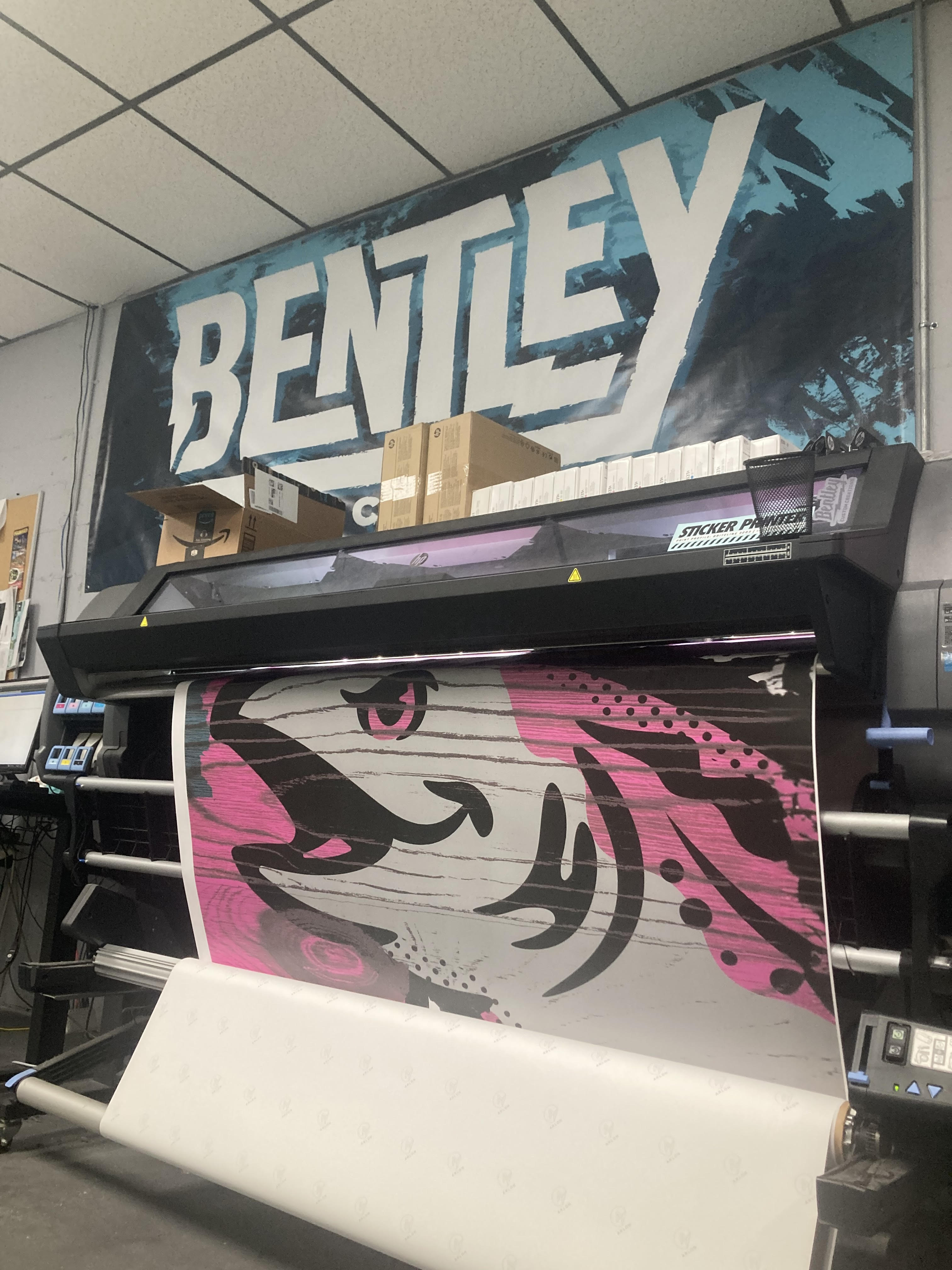 large format printer running a print job on a roll of vinyl