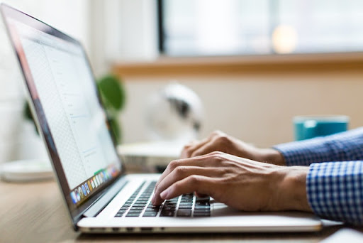 A man types on his computer