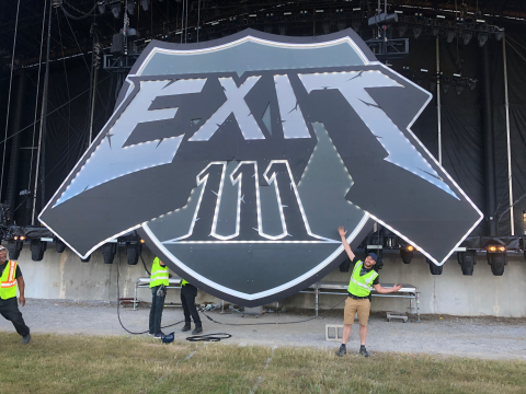 exit 111 illuminated sign at concert venue.