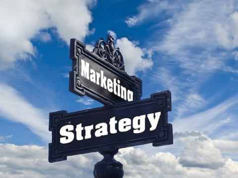A street sign showing the words “marketing” and “strategy”.