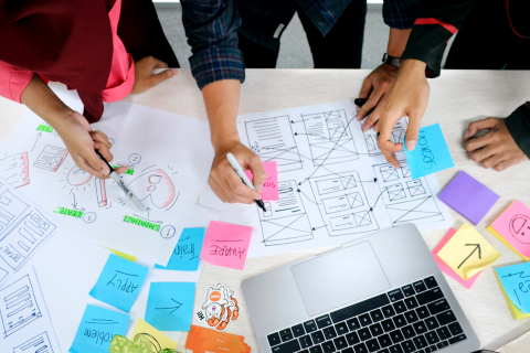 Team brainstorming with notes on a table.